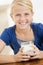 Young girl indoors drinking milk smiling