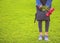 Young girl in jeans with bouquet of tulips flowers and bag walks in park