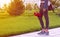 Young girl in jeans with bouquet of tulips flowers and bag walks in park