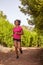 A young girl jogging on a trail