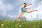 Young girl jumping in meadow