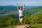 Young girl jumping on the mountains top