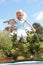 Young Girl Jumping On Trampoline In Garden