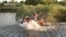 Young girl jumps gallop into a lake on horseback.