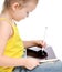 Young girl kid sitting reading learning drawing on digital tablet touch screen pad with pencil