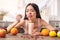 Young girl at kitchen healthy lifestyle sitting eating smoothie looking at spoon foretasting