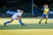 Young girl lead the ball in attack during field hockey game