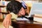 Young Girl in library with laptop and headphones