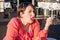 Young Girl Licking Straw From Her Coffee Cup and Enjoying Beautiful Sunny Day Outside