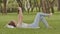 A young girl lies on her back in the green grass with a smartphone in her hands. Fun posing on camera phone. Recreation