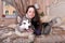 Young girl in a lilac dress with her malamute