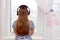 Young girl is listening to music with headphone and looking in w
