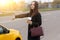 Young girl with long hair, asking taxi stop