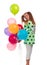 Young girl with long hair in a green tunic with a star with balloons posing on a white background