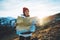 Young girl look and hold in hands map, people planning trip, hipster tourist on background sun flare nature, enjoy journey land