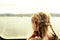 Young girl looking through a boat window.