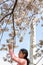 Young Girl Looking at Cherry Blossoms in Washington DC with the Washington Monument in the Background