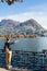 Young girl looking and pointing at the panoramic scenery. Lugano, Switzerland