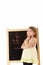 Young Girl Looking Thoughtful Next To Blackboard