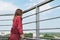 A young girl looks at the city from a panoramic balcony