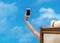 Young girl lying on a beach with mobile telephone