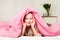 Young girl lying on the bed under the covers