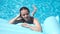 Young girl lying on a mattress in the pool