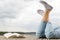 Young girl lying on a pier next a book