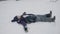 A young girl makes a snow angel by lying on her back in the snow and moving her arms and legs