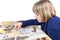 Young girl making jigsaw puzzle on table