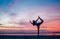 Young Girl making natarajasana yoga pose on the sunset seaside. Active day beginning concept image