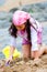 Young girl making sandcastle