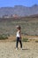 Young girl in the middle of the desert with a view of some beaut