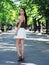 Young girl model posing at the park standing and looking back at camera