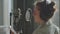 A young girl in monitor headphones in front of a microphone records a podcast