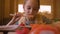 Young girl mouth eat sushi with red salmon. By wooden chopsticks