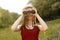 Young girl on nature with hat and binocular. Summer