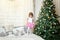 Young girl near a Christmas tree