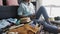 A young girl near a travel suitcase looks at social networks on the smartphone, chatting with friends