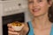 Young girl offers freshly baked muffin with fruit