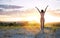 Young girl with open arms freely at mountain top against sunset in Murcia, Spain. Walking and enjoying freedom in countryside.