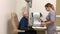 A young girl ophthalmologist conducts an eye test for an elderly man in a modern ophthalmological clinic. Eye