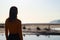 Young girl out of focus looking at the horizon on the beach