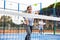 Young girl paddle tennis player performing forehand