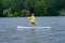 Young girl paddling on SUP board on a calm lake at city. Sup surfing woman. Awesome active training in outdoor