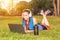 A young girl in a park on the grass After fitness training with laptop and headphones
