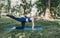 young girl perform complex yoga exercises in the park outdoors