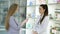 Young girl pharmacist advises pregnant customer. Pharmaceutical store concept
