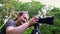 A young girl, a photographer, in a forest area, takes pictures of beautiful nature.