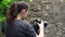 A young girl, a photographer, in a forest area, takes pictures of beautiful nature. Close-up.